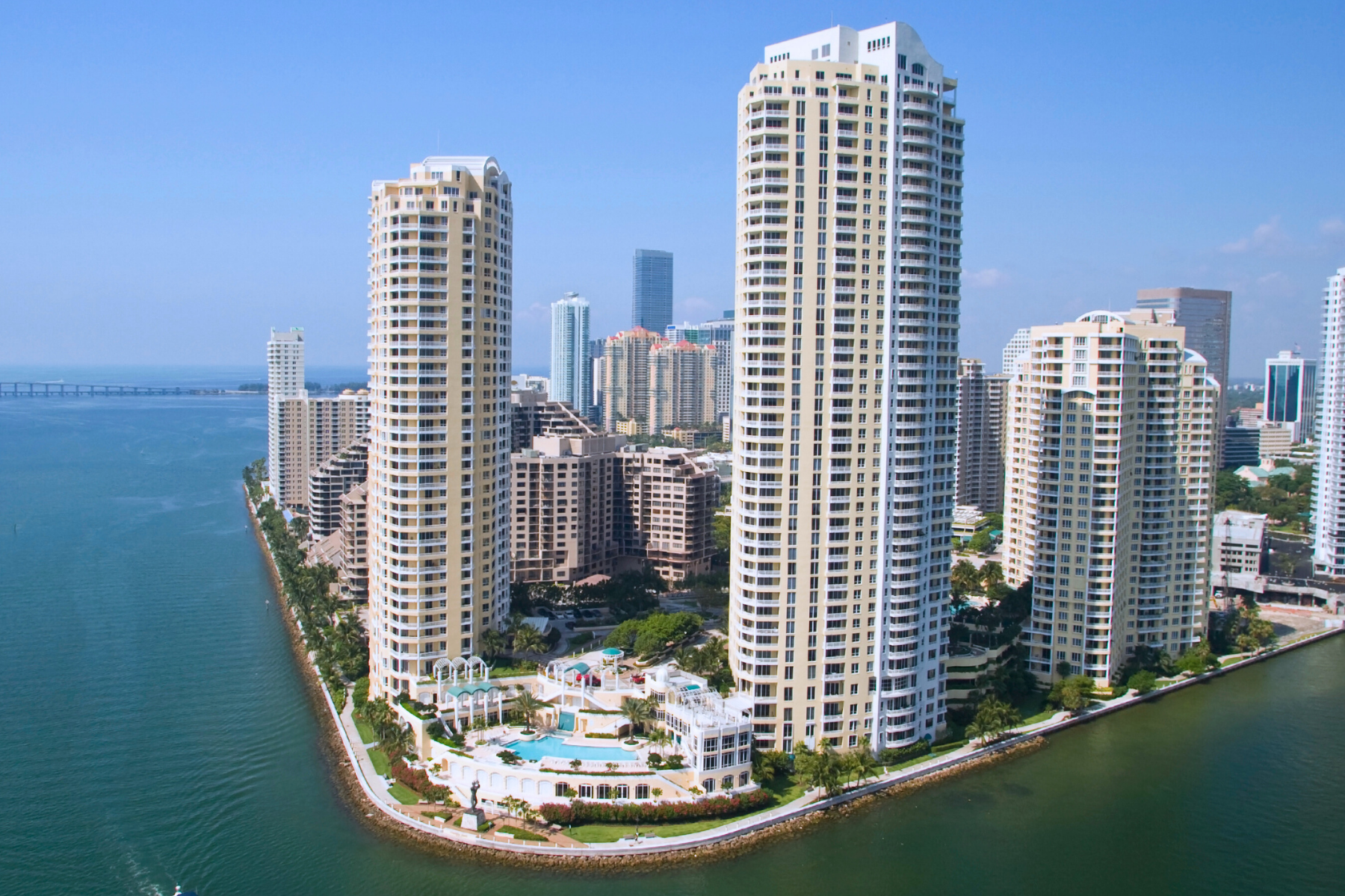 waterfront real estate High-rise commercial buildings along a coastal cityscape, highlighting SBA 504 loan eligibility for real estate acquisition and development.